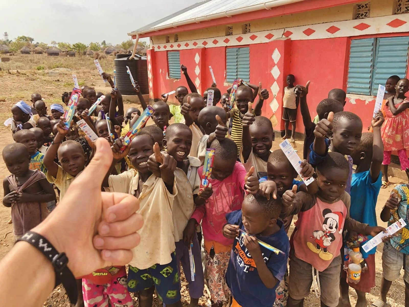 Local kids giving our missionary insurance member the thumbs up after some fun and games.