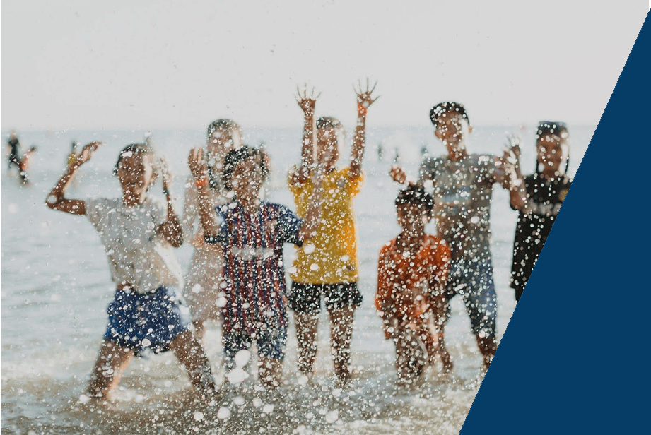 Children playing at the beach, linked to our Program helping missionaries with their finances