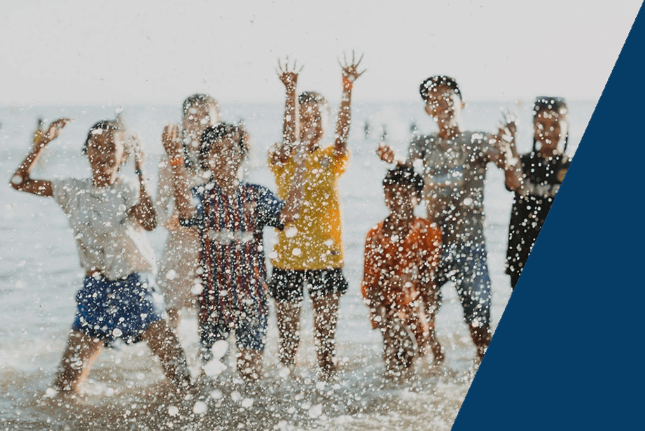 Children playing at the beach, linked to our Program helping missionaries with their finances