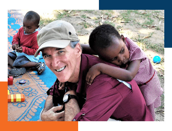 Young child is resting on the back of a missionary with our international travel medical policy